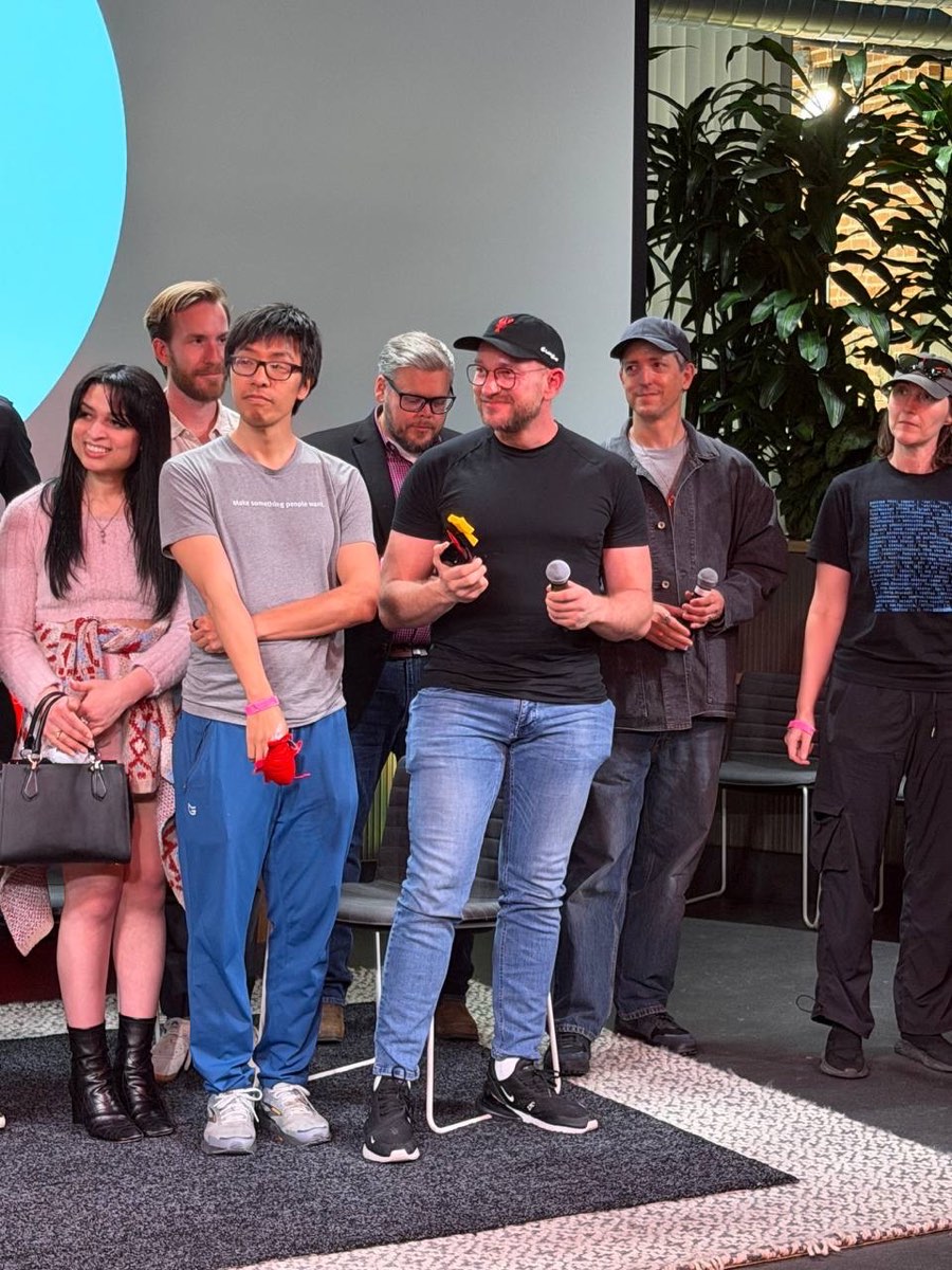 A group of seven people standing together on stage at the end of the event.